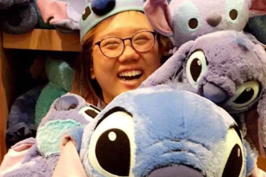 Melanie Ho in a bin with stuffed animals